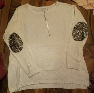 White sweater with sequin elbow patches